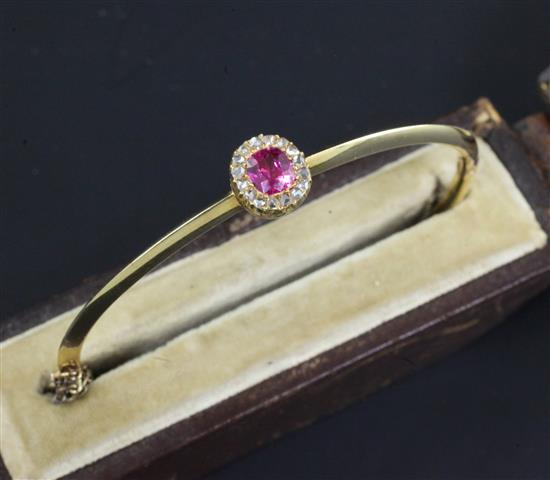 A Victorian gold, ruby and diamond cluster hinged bangle,